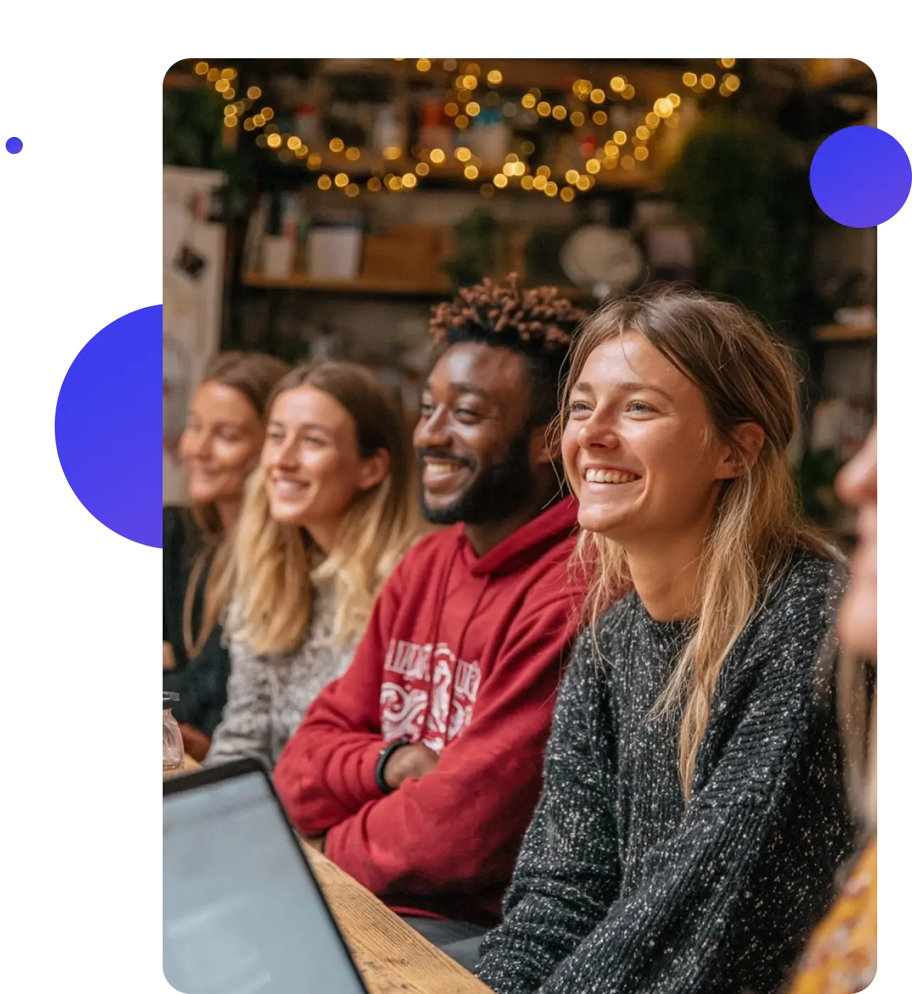 Youth workers and young people together in a community space, talking and laughing.
