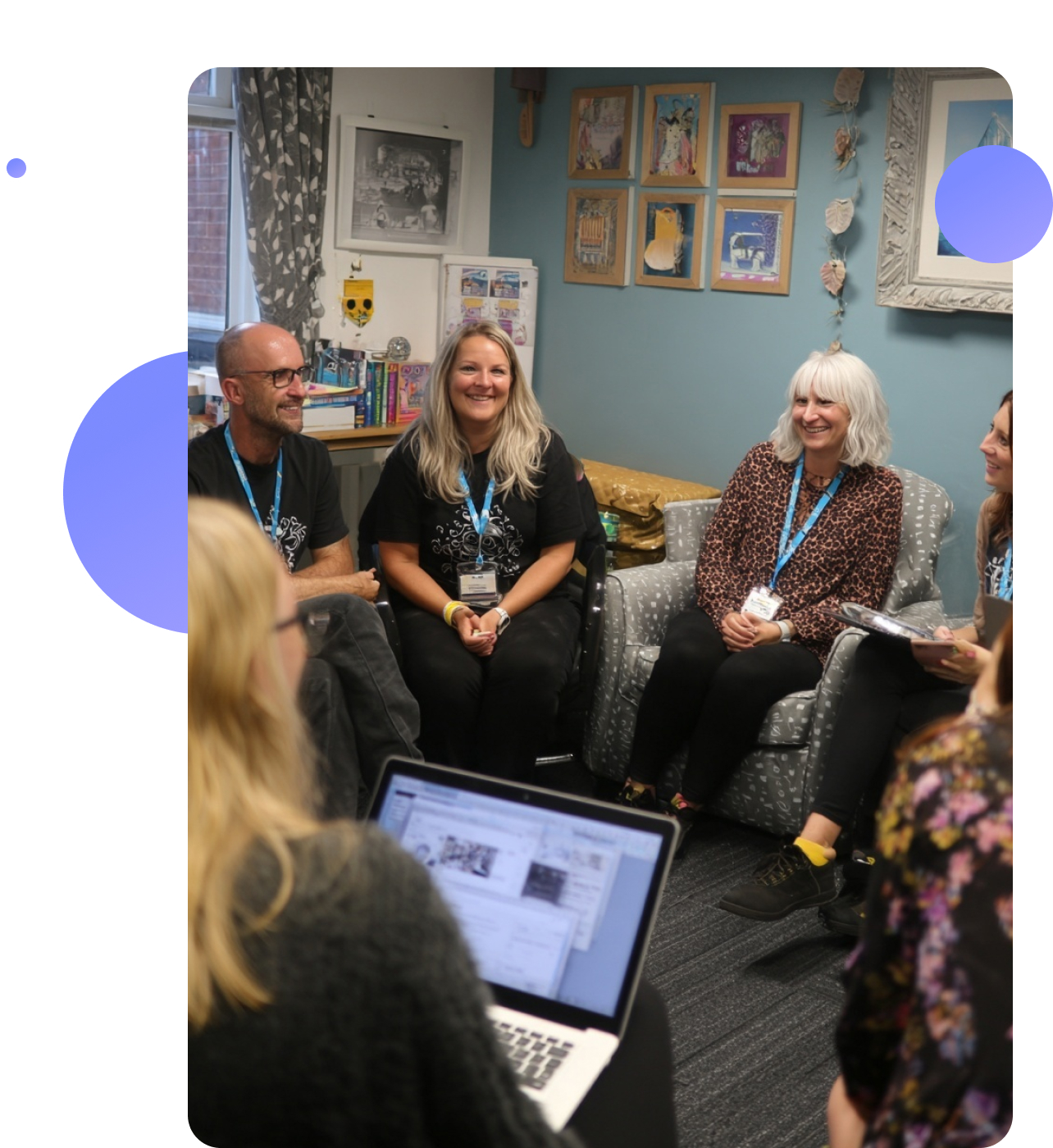 A care worker sitting with a young person in a homely setting, listening attentively in a calm and supportive conversation.