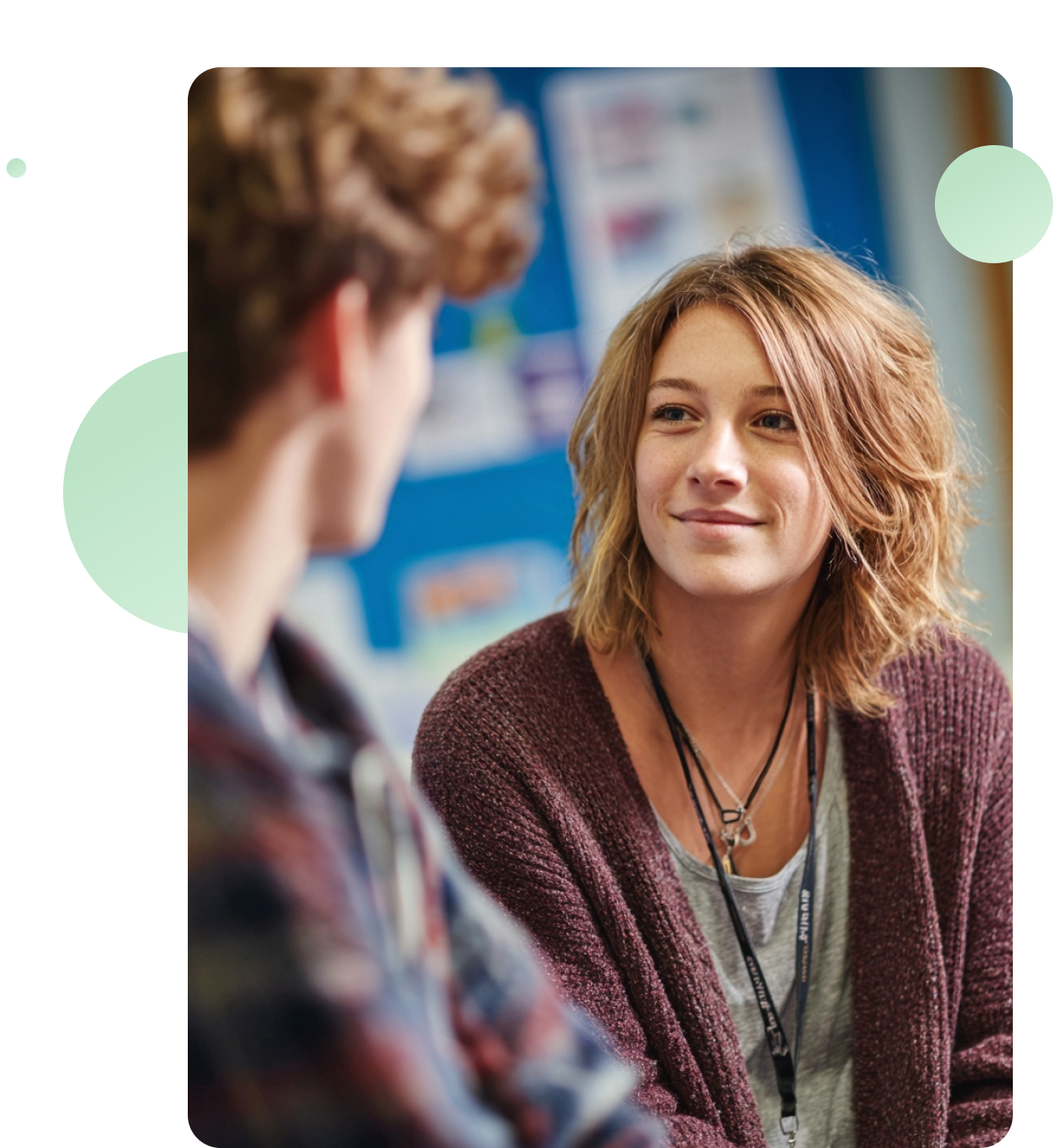 A mental health practitioner and client sitting face to face in a softly lit room, engaged in a thoughtful conversation.