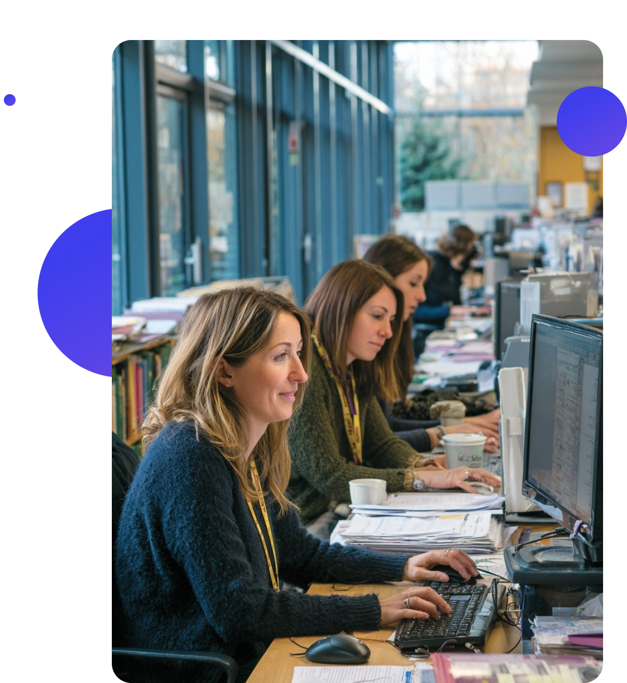A local authority team in a formal meeting room, sitting around a table with laptops and papers, discussing plans in natural daylight.