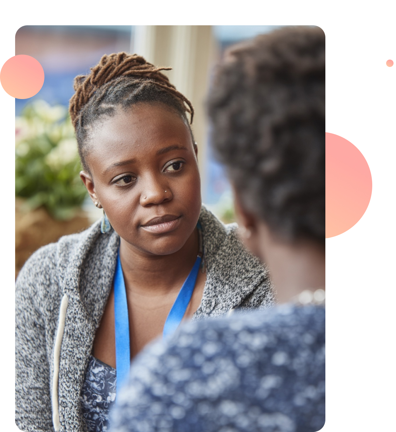 A youth worker talking with a young person in an informal setting, showing empathy and understanding.